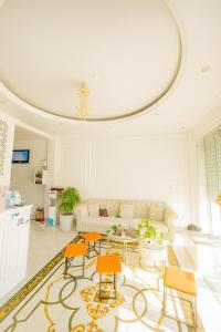 a living room with a couch and a table and chairs at King Hotel Hải Phòng in Hai Phong