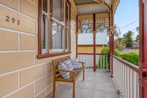 a porch with a bench and a window at Cathedral View - Sleeps 16 in Bendigo