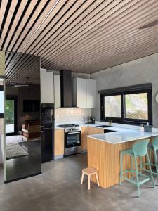 a kitchen with a large island in the middle at Chapel Cove Retreat - Private Tiny House with Boat Ramp in Sackville Reach