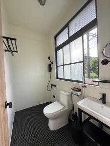a bathroom with a white toilet and a sink at 台東依三山民宿 尚武館 in Dawu +25 photos