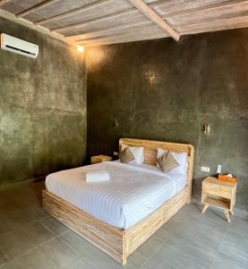 a bedroom with a large bed in a room at Menjangan Dive Lodge in Banyuwedang