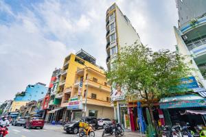 a busy city street with buildings and cars at Rocky Hotel Ho Chi Minh in Ho Chi Minh City