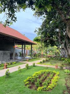 a garden with a gazebo in a park at Menjangan Dive Lodge in Banyuwedang