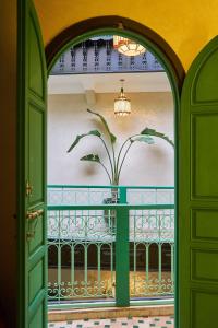 an open door with a plant on a balcony at Riad Lia ou Lik in Marrakesh +62 photos