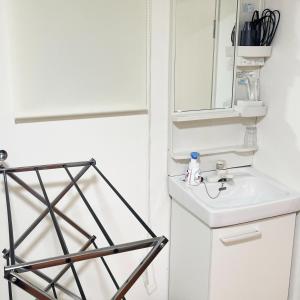 a bathroom with a sink and a mirror at OLIVE Stay in Fukuoka +40 photos