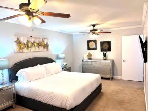una camera da letto con un letto e un ventilatore a soffitto di Spacious 2BD Condo Grand Prairie GP22B a Heliport-Facility 5A