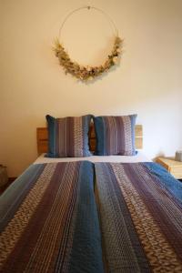 a bedroom with a bed with a wreath on the wall at Casa Holamundo in Curtina
