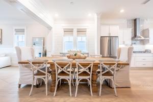 a kitchen with a wooden table and chairs at Happily Eva After at Prominence 30A in Inlet Beach