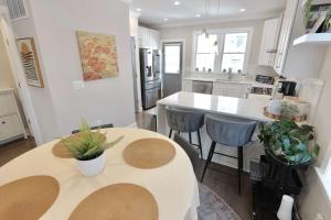 a kitchen with two tables and a counter in it at The Brightwood House - Family Living in the Heart of DC in Washington