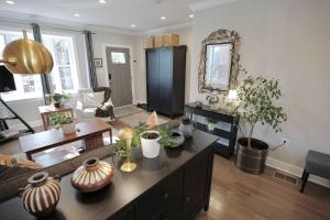a living room with a table with vases on it at The Brightwood House - Family Living in the Heart of DC in Washington