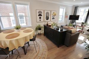 a living room with a table and a couch at The Brightwood House - Family Living in the Heart of DC in Washington +24 photos