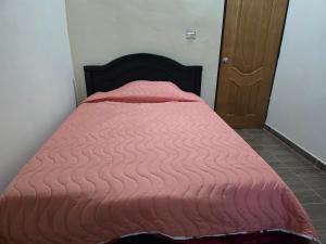 a bed with a pink comforter in a room at Finca La Preciosura in Horizonte +5 photos