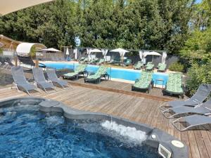 a swimming pool with lounge chairs and a swimming pool at ZEcamping 4 étoiles pet friendly piscine et pétanque au cœur des Alpilles in Noves