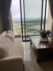 a living room with a couch and a table at 2BR Cozy Apartment- River and Park View- Masteri Centre Point - HCM in Ho Chi Minh City