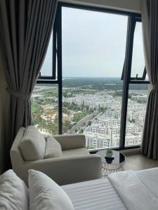 a hotel room with a bed and a large window at 2BR Cozy Apartment- River and Park View- Masteri Centre Point - HCM in Ho Chi Minh City