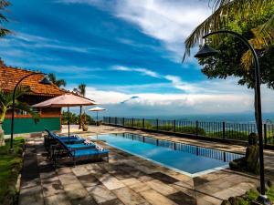 a swimming pool with a view of the ocean at Villa Borobudur Resort in Borobudur