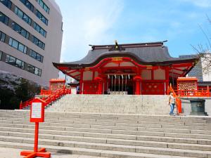 a person standing in front of a building with stairs at Higashi-Shinjuku 904 in Tokyo
