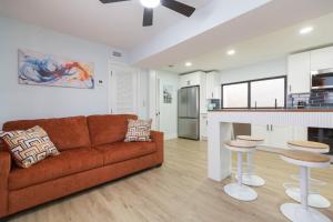 a living room with a couch and a kitchen at Clearwater Bliss Apartment 3 in Clearwater Beach