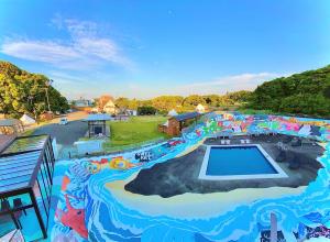 a painting of a water park with a swimming pool at Kabuku Resort in Shima