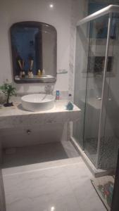 a bathroom with a sink and a shower at martinshouse in Cabo Frio