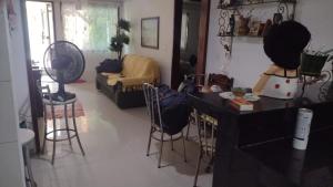 a living room with a counter and stools in a room at martinshouse in Cabo Frio