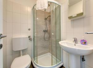 a bathroom with a shower and a toilet and a sink at Villa Katarina Studio Apartments in Dubrovnik +25 photos