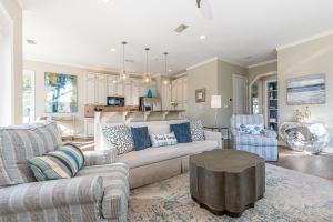 a living room with a couch and a table at IncogBeachO in Santa Rosa Beach