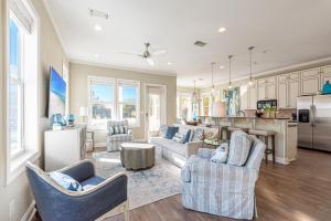 a living room with couches and a kitchen at IncogBeachO in Santa Rosa Beach