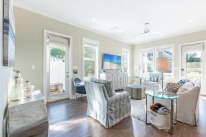 a living room with chairs and a table at IncogBeachO in Santa Rosa Beach
