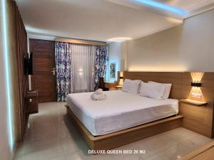 a bedroom with a large bed with white sheets at Bali Balitung in Seminyak
