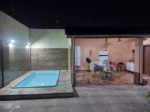 a swimming pool in the middle of a house at Casa Mosqueiro in Belém +7 photos