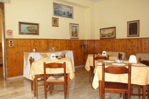 a dining room with two tables and two chairs at Albergo Miramonte in Vibo Valentia