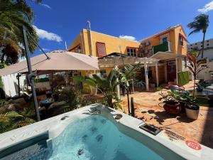 a swimming pool in front of a house at Sinclair Boutique Hotel in Hollywood