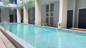 una gran piscina en un edificio con piscina en Sunrise Hotel Malang, en Rampal