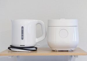 two white appliances sitting on a wooden shelf at Higashi-Shinjuku 906 in Tokyo