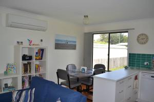 a living room with a blue couch and a table at Lees171 in Evergreen