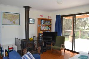 a living room with a fireplace and a desk with a television at Lees171 in Evergreen