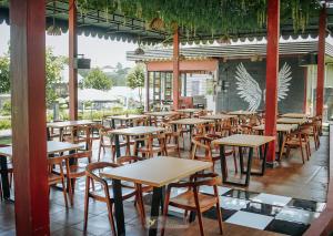 a row of tables and chairs in a restaurant at The Kotenang in Wonosobo