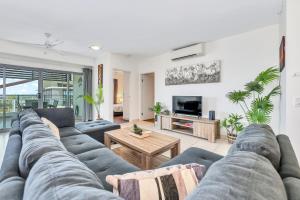 a living room with a couch and a table at Luxury in Litchfield Street - Heart of the CBD in Darwin