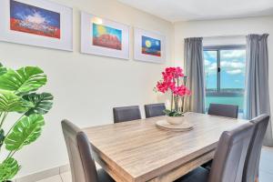 a dining room with a wooden table and chairs at Luxury in Litchfield Street - Heart of the CBD in Darwin