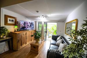 a living room with a couch and a table at Loft Apartment - 1 Bedroom in Brunswick Heads