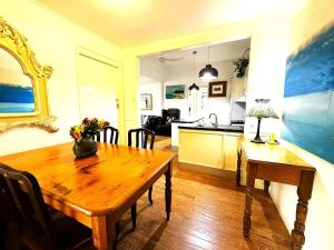 a dining room with a wooden table and a kitchen at Loft Apartment - 1 Bedroom in Brunswick Heads