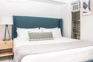 a bedroom with a large bed with a blue headboard at Cruz Bay Oasis Walk to Beach & Stunning Views in Enighed