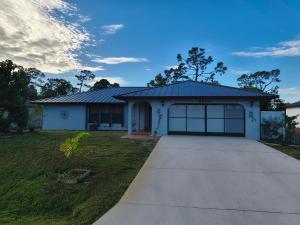 a house with a garage with a driveway at Prada Home Club in Punta Gorda