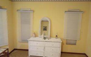 a bedroom with a white dresser and a mirror at Prada Home Club in Punta Gorda