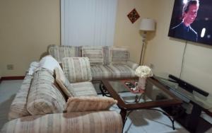 a living room with a couch and a table at Prada Home Club in Punta Gorda