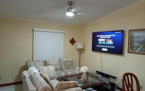 a living room with a couch and a tv at Prada Home Club in Punta Gorda