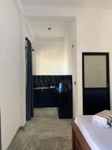 a bathroom with a sink and a bed in a room at The Rosemary House in Weligama