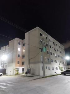 a large white building at night with a parking lot at FLAT ACONCHEGANTE poucos min da praia in Maceió +61 photos