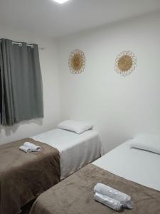 Ένα ή περισσότερα κρεβάτια σε δωμάτιο στο FLAT ACONCHEGANTE poucos min da praia